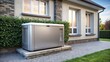 © Wanlop - A modern stainless steel residential standby generator installed on a house exterior wall with a sleek and compact design.