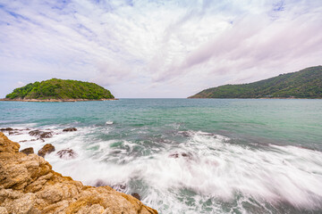 Huge waves crashed against the rocks until the water splashed..Small island in the green sea near Yanui Beach There are rocks and coral reefs for snorkeling and a sandbar between the two beaches..