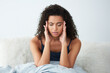 © Chanelle2000/peopleimages.com - Woman, waking up and headache in bedroom with stress, fear or frustrated for insomnia or mental fatigue. African person massage head for pain, anemia or tired in morning with iron deficiency at home
