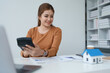 © Jirapong - Smart Mortgage Planning woman using a calculator to make Calculations and Consideration