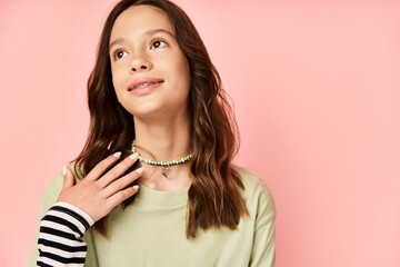 Wall Mural - A stylish teenage girl poses energetically in a green shirt and black & white striped skirt, exuding confidence and vibrancy.