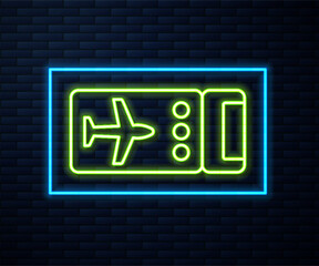 Canvas Print - Glowing neon line Airline ticket icon isolated on brick wall background. Plane ticket. Vector