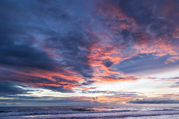 Colorful sunset over the sea. Sunset on Khao Lak beach in Thailand. Sandy beach with colorful sky and dramatic clouds