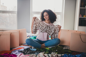 Poster - Full body photo of pretty young woman sit messy stack clothes shop bags blouse house indoors