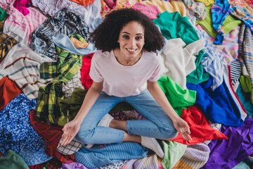 Sticker - Full size high angle view photo of young woman sit meditate messy pile stack clothes apartment indoors