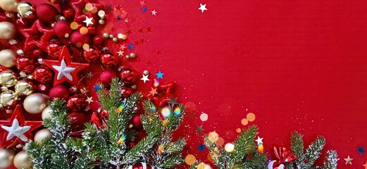 Wall Mural - beautiful colorful red christmas background with a border of gold stars, balls and green fir branche