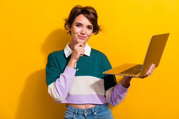 Poster - Photo of pretty nice young girl think hold laptop wear shirt isolated on yellow color background