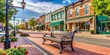 © sujanya - Park bench in small town USA main street with commercial storefronts, small town, USA, main street