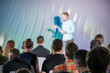 © Anton Gvozdikov - Group of people attending a business presentation, focusing on the speaker at the front of the room. Professional setting for corporate or educational event.