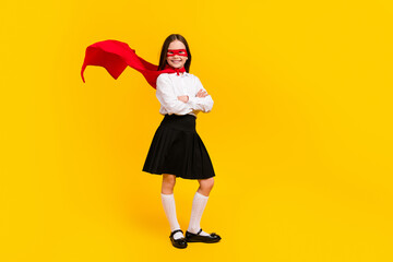 Poster - Full size photo of cute schoolgirl superhero crossed arms empty space wear uniform isolated on yellow color background