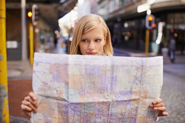 Canvas Print - I think Im lost...Shot of a young woman holding a map while touring abroad.