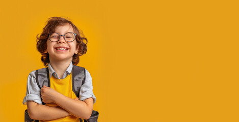 Portrait of a happy schoolboy on a color background.