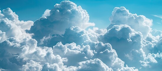 Poster - Cloudscape background with a blue sky filled with white fluffy clouds ideal for a copy space image