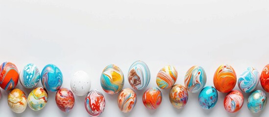 Canvas Print - Minimalistic flat lay of marbled painted eggs on a white background with copy space image