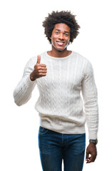 Wall Mural - Afro american man over isolated background doing happy thumbs up gesture with hand. Approving expression looking at the camera with showing success.