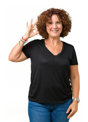 Poster - Beautiful middle ager senior woman over isolated background smiling positive doing ok sign with hand and fingers. Successful expression.