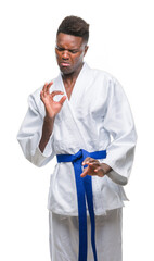 Sticker - Young african american man over isolated background wearing kimono disgusted expression, displeased and fearful doing disgust face because aversion reaction. With hands raised. Annoying concept.