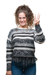 Canvas Print - Beautiful brunette curly hair young girl wearing glasses over isolated background showing and pointing up with fingers number three while smiling confident and happy.