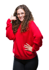 Poster - Beautiful brunette curly hair young girl wearing glasses and winter sweater over isolated background smiling doing phone gesture with hand and fingers like talking on the telephone. Communicating