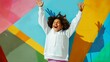 © PSCL RDL - Teenage girl wearing a white hoodie with no print or logo standing in front of colorful wall, raising hands in excitement, apparel mockup photo, African-American child