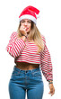 © Krakenimages.com - Young beautiful woman wearing christmas hat over isolated background looking stressed and nervous with hands on mouth biting nails. Anxiety problem.