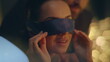 © stockbusters - Woman removing eyes bandage reacting romantic surprise night atmosphere closeup