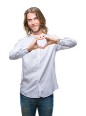 Sticker - Young handsome man with long hair over isolated background smiling in love showing heart symbol and shape with hands. Romantic concept.