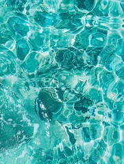 Wall Mural - Sea surface in a turquoise lagoon, top view. The texture of sea water. Transparent turquoise sea water, natural background. Summer and travel vacation concept.