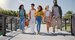 © SneakyPeakPoints/peopleimages.com - Walking, conversation and friends at university with fun for learning, bonding and talking. People, diversity and group of gen z students on outdoor bridge ready for education at college campus.