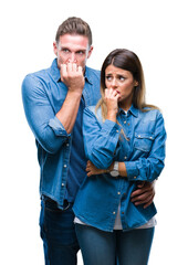 Canvas Print - Young couple in love over isolated background looking stressed and nervous with hands on mouth biting nails. Anxiety problem.