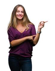 Sticker - Young beautiful blonde elegant woman over isolated background with a big smile on face, pointing with hand and finger to the side looking at the camera.