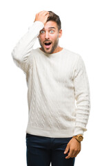 Poster - Young handsome man wearing winter sweater over isolated background surprised with hand on head for mistake, remember error. Forgot, bad memory concept.