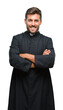 © Krakenimages.com - Young catholic christian priest man over isolated background happy face smiling with crossed arms looking at the camera. Positive person.