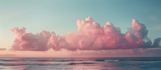 Fototapete - Peaceful seascape at dusk with pink tones in the sky and dramatic clouds perfect as a copy space image
