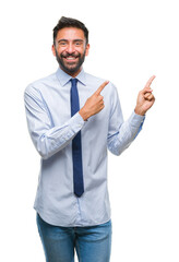 Canvas Print - Adult hispanic business man over isolated background smiling and looking at the camera pointing with two hands and fingers to the side.