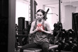© New Africa - Heart attack. Young woman suffering from pain and pressing hands to chest at gym