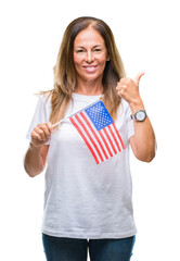 Sticker - Middle age hispanic woman holding flag of United States of America over isolated background happy with big smile doing ok sign, thumb up with fingers, excellent sign