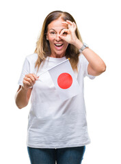 Sticker - Middle age hispanic woman holding flag of Japan over isolated background with happy face smiling doing ok sign with hand on eye looking through fingers