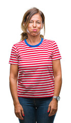 Sticker - Middle age senior hispanic woman over isolated background puffing cheeks with funny face. Mouth inflated with air, crazy expression.