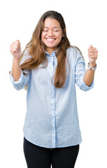 Wall Mural - Young beautiful brunette business woman over isolated background excited for success with arms raised celebrating victory smiling. Winner concept.