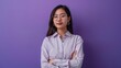 © Usman - Young asian buisnesswoman wearing eyeglasses arms crossed standing against purple background