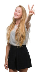 Poster - Blonde teenager woman wearing moles shirt smiling looking to the camera showing fingers doing victory sign. Number two.