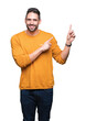 © Krakenimages.com - Young handsome man over isolated background smiling and looking at the camera pointing with two hands and fingers to the side.