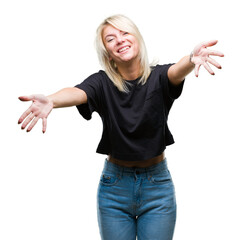 Wall Mural - Young beautiful blonde woman over isolated background looking at the camera smiling with open arms for hug. Cheerful expression embracing happiness.