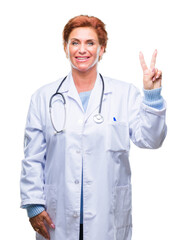 Canvas Print - Senior caucasian doctor woman wearing medical uniform over isolated background showing and pointing up with fingers number two while smiling confident and happy.