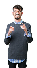 Canvas Print - Young handsome smart man wearing glasses over isolated background pointing fingers to camera with happy and funny face. Good energy and vibes.