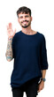 © Krakenimages.com - Young handsome man over isolated background Waiving saying hello happy and smiling, friendly welcome gesture