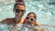 © Usman - Mother and daughter enjoy a summer afternoon in a swimming pool, both wearing sunglasses and smiling. Their playful interaction and shared fun capture the essence of a family vacation
