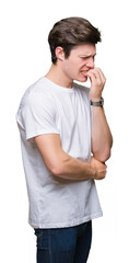 Wall Mural - Young handsome man wearing casual white t-shirt over isolated background looking stressed and nervous with hands on mouth biting nails. Anxiety problem.