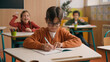 © Yuliia - Caucasian little boy kid schoolboy nerd in glasses write task class lesson school education angry children cruel throw crumpled paper balls abuse abusing bullying classmates studying problem mock